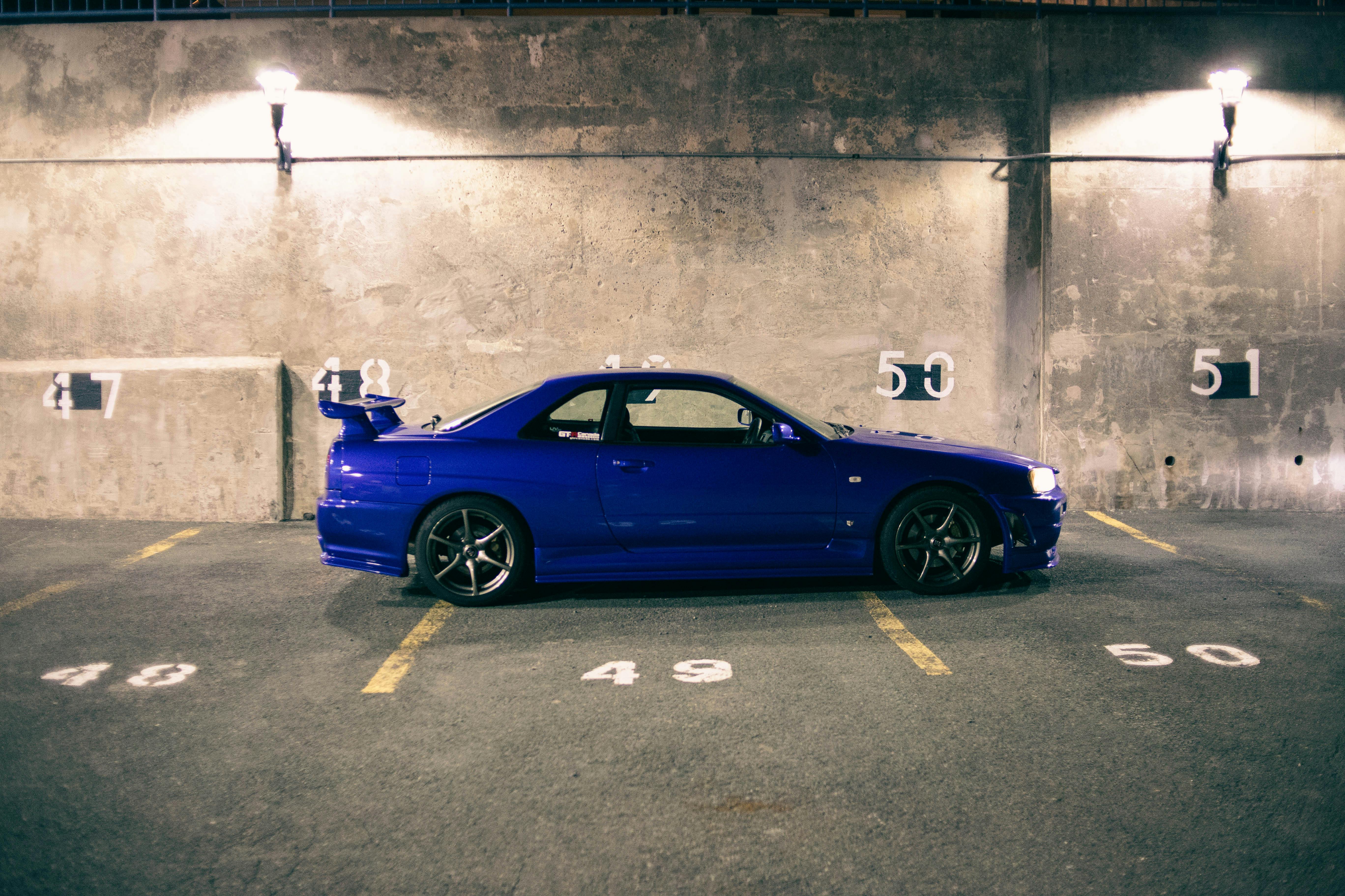 A blue sports car parked in a parking lot photo – Free California Image on  Unsplash