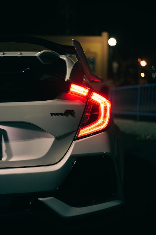 Free Close Up Photo of White Car at Night Time Stock Photo