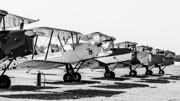 Grayscale Photo Of Biplanes