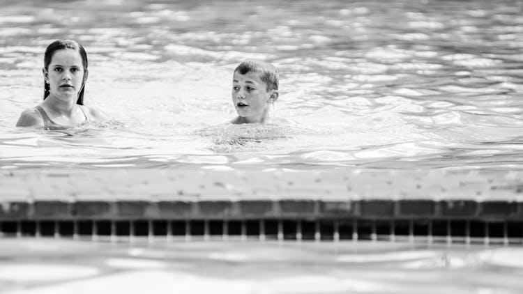 Grayscale Photo Of Woman And A Boy In The Swimming Pool