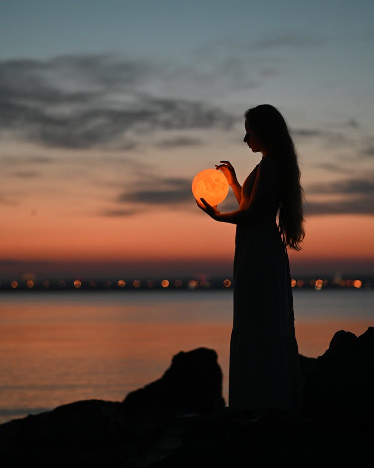 A Woman Holding An Orb