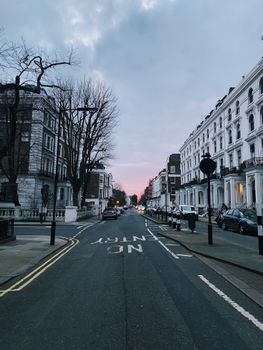 Discover a picturesque London street scene at dusk featuring classic architecture and tranquil urban vibes.