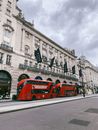 Double Decker Buses in front of the Dilly Hotel in London