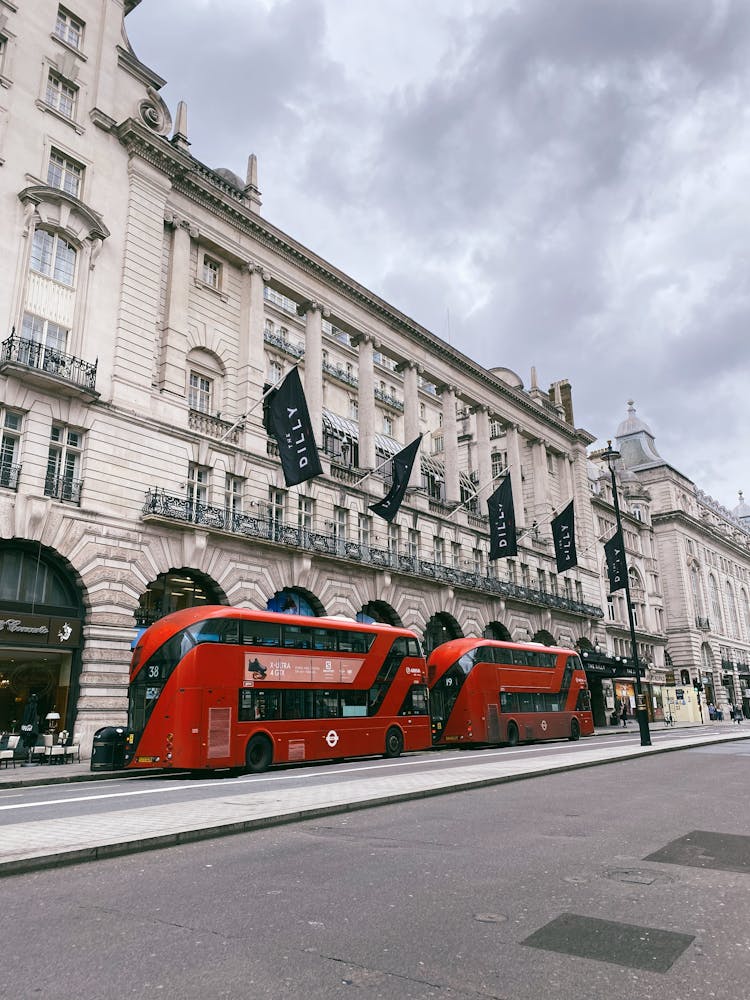 Double Decker Buses In Front Of The Dilly Hotel In London