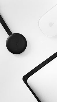 Top-down view of a clean workspace featuring modern tech gadgets and minimalistic design.