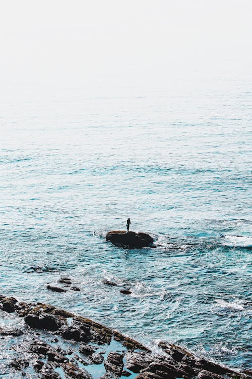 Person Standing on Rock Formation