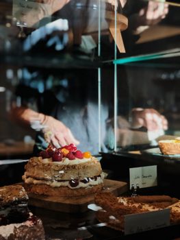 A delicious assortment of cakes and pastries elegantly displayed in a cafe setting.