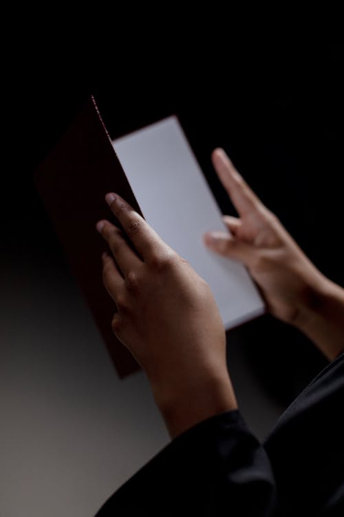 Human hands holding openned diploma