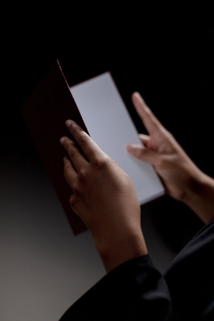 Human Hands Holding Openned Diploma