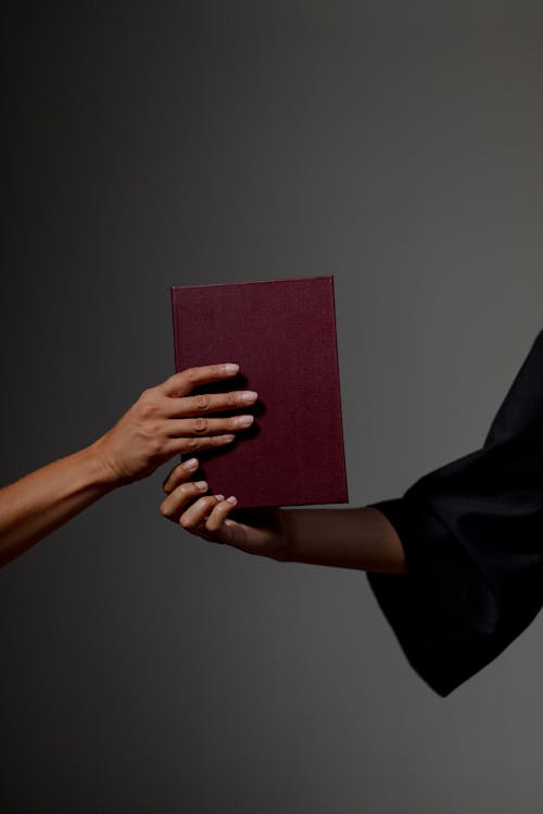 Human hands holding diploma