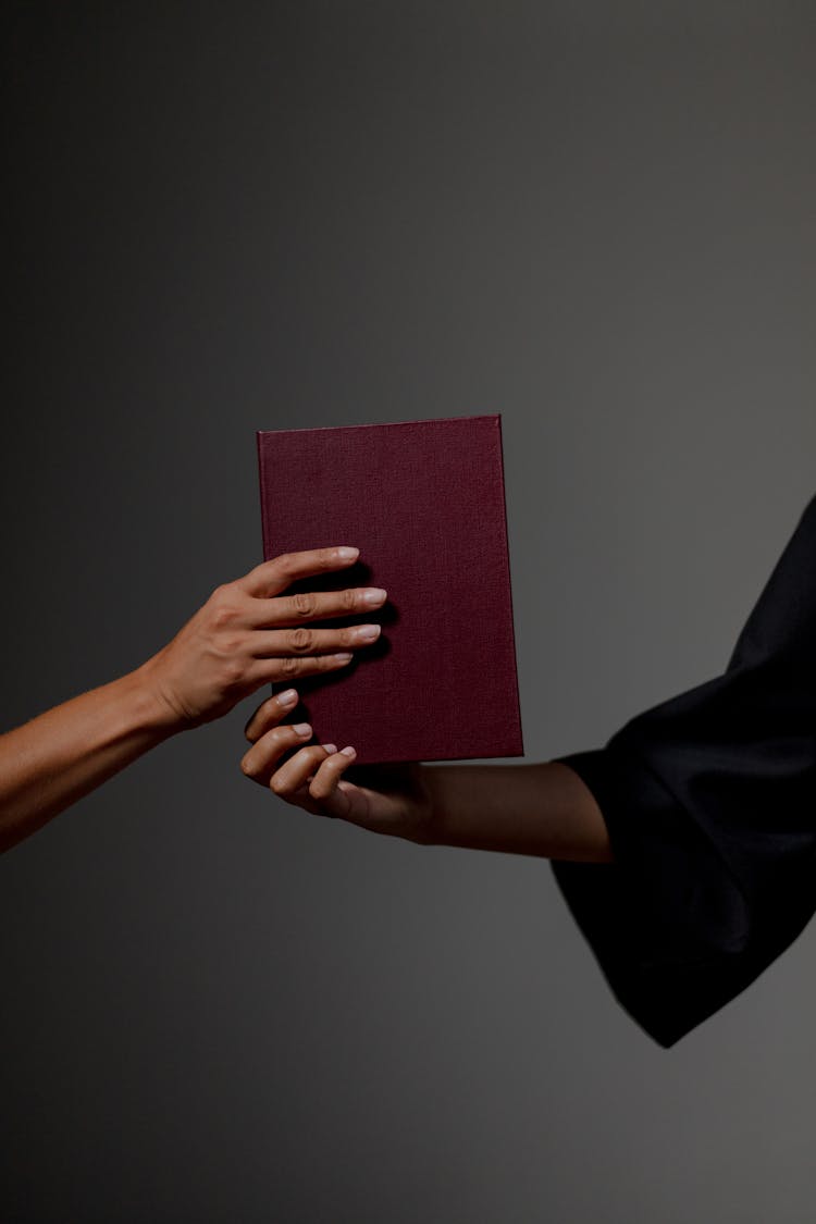 Human Hands Holding Diploma