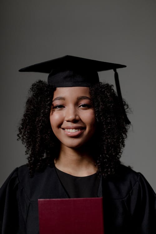 Woman with Curly Hair Wearing Mortarboard