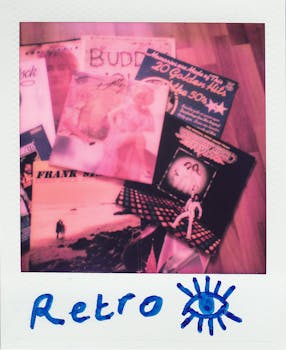 A collection of vintage vinyl record covers captured in a retro Polaroid photograph.