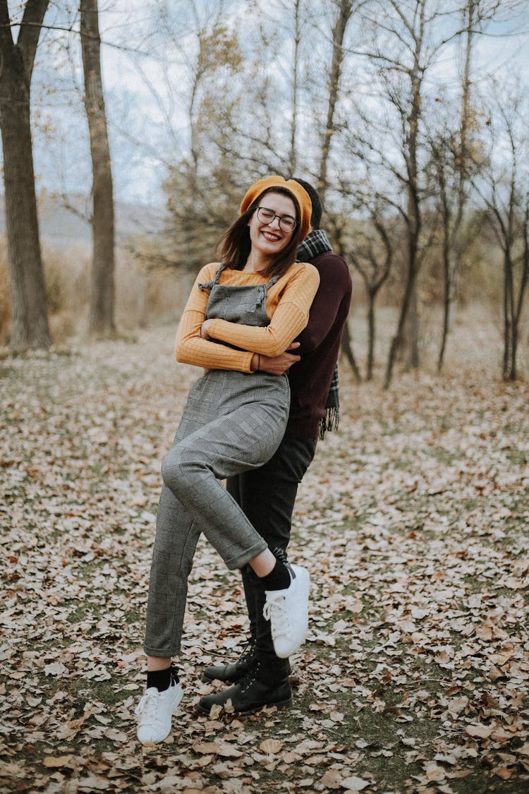 Happy Couple Hugging In Autumn Forest