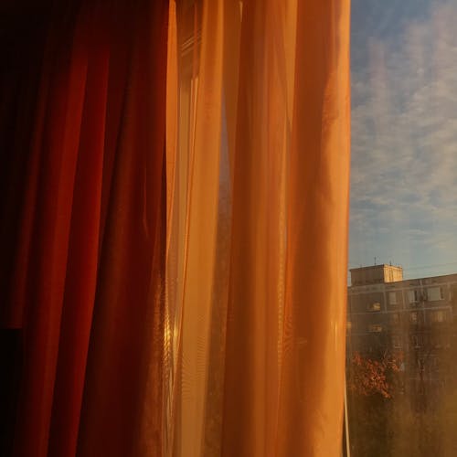 Orange curtains in front of window