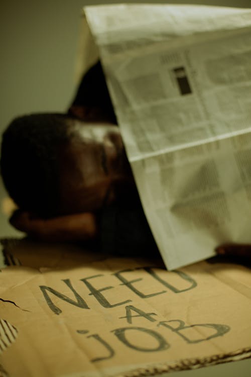 Homeless man sleeping on cardboard