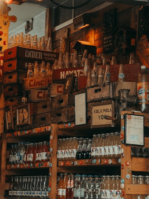 Brown Wooden Shelves and Crate Boxes With Bottles