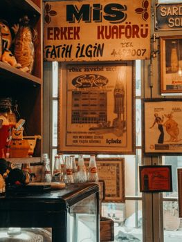 Retro indoor scene of vintage signs and old-fashioned bottles in a cozy bar setting.