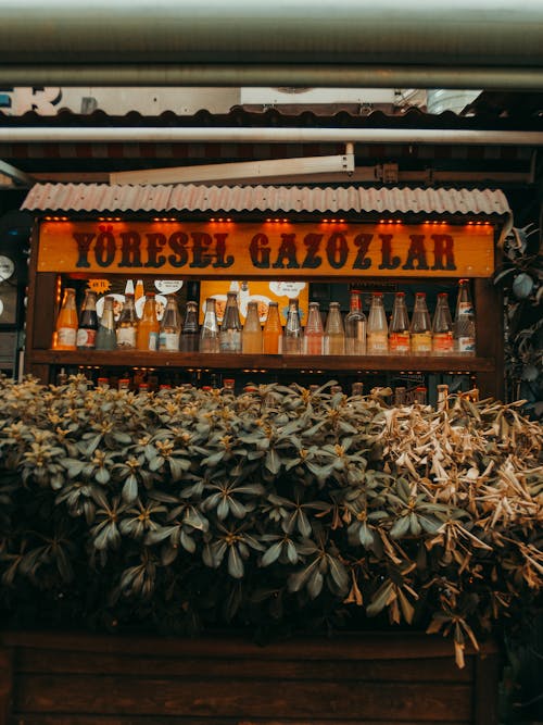 Soda bottles on shelf and sign with text