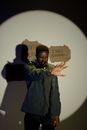Standing man and cardboard with unemployment issues slogans