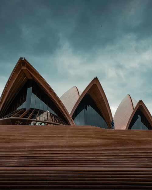 Free Dramatic view of Sydney Opera House against an overcast sky. Stock Photo