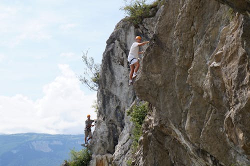 Men Climbing a Cliff