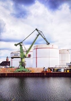 A large bulk-handling crane at a busy industrial harbor.