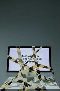 Computer tied with black and yellow tape