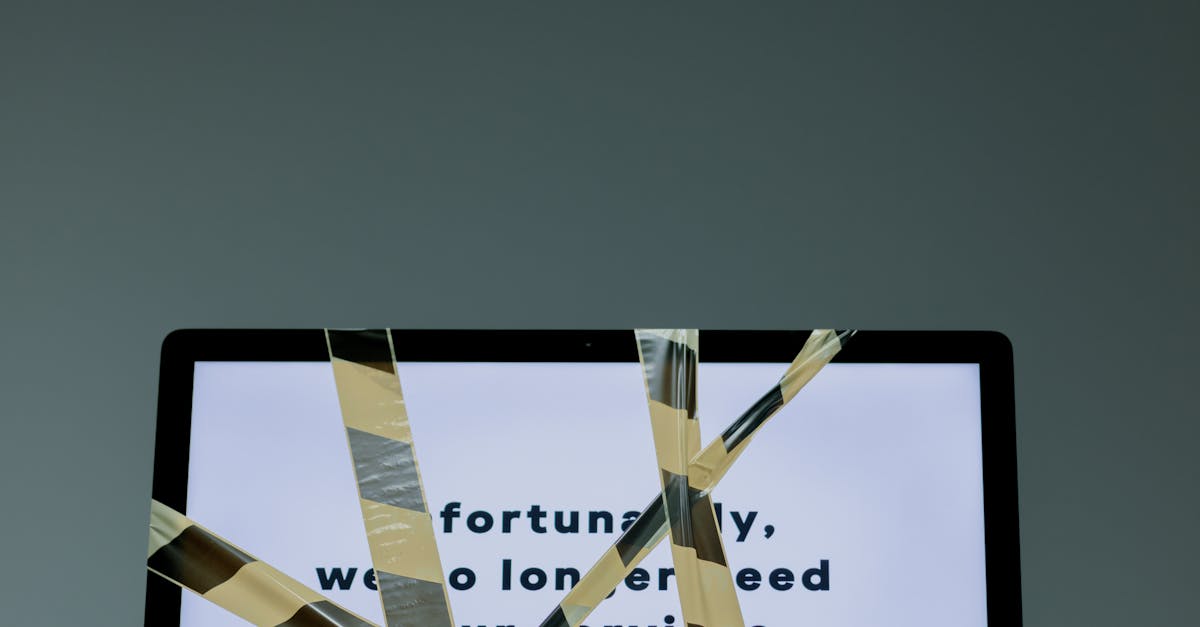 Computer tied with black and yellow tape · Free Stock Photo