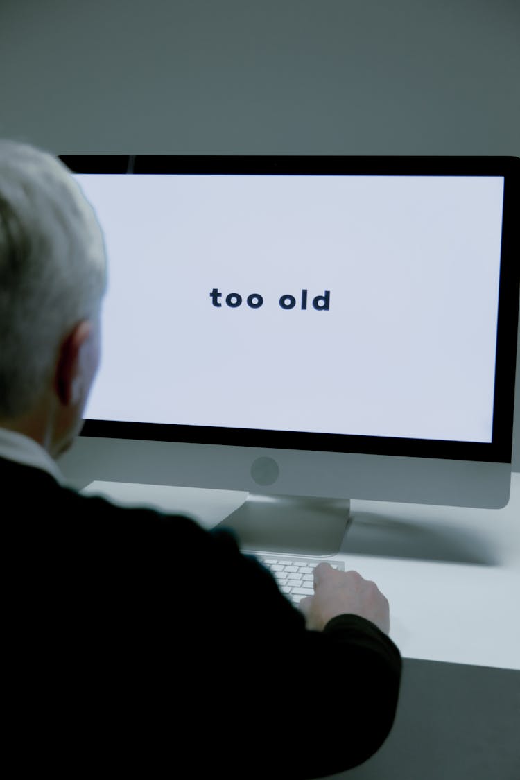 A Man Sitting Beside The Computer