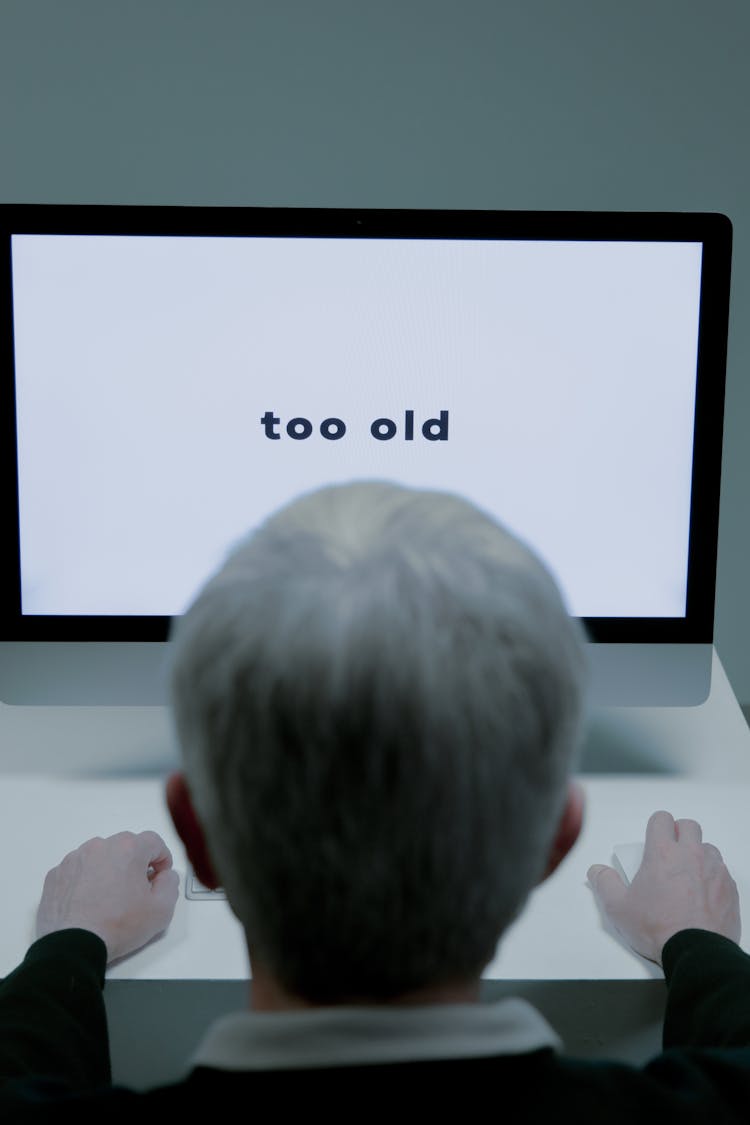 An Elderly Man Facing The Computer Monitor