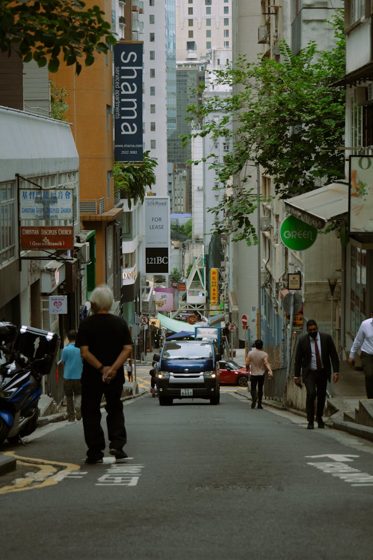 Car And Pedestrians On Narrow Street