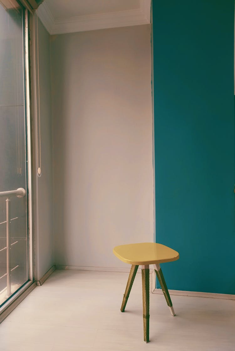 Yellow Chair In Room With White And Blue Walls