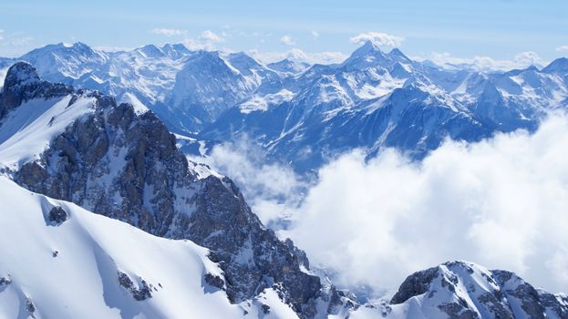 Breathtaking view of snow-covered mountains under a clear blue sky in Styria, Austria.