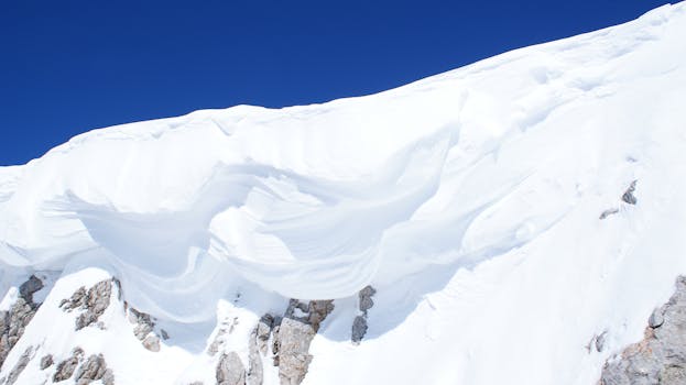 Majestic snow-covered mountain against a blue sky in the Austrian Alps.