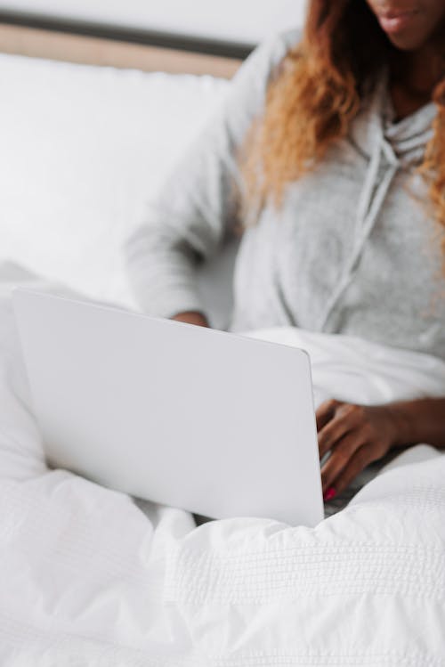 Free Woman with laptop on bed Stock Photo