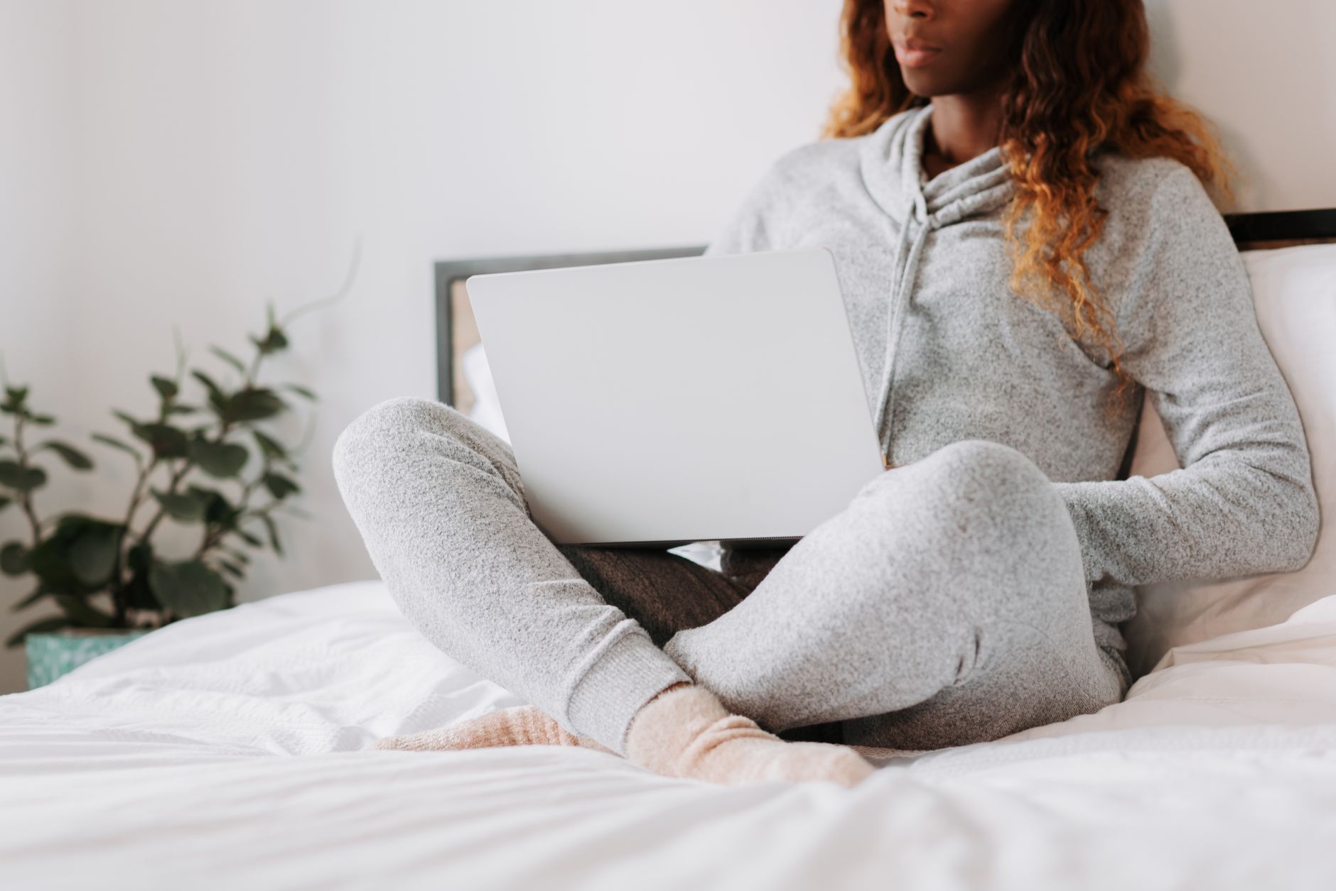 adhd executive dysfunction can't do anything executive dysfunction adhd paralysis โ woman sitting cross-legged bed laptop closed looking tired soft morning light