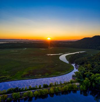 Breathtaking sunset over the lush countryside and winding Trempealeau River in Wisconsin.