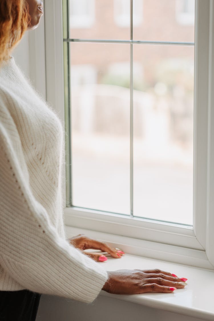 Woman Looking Through Window