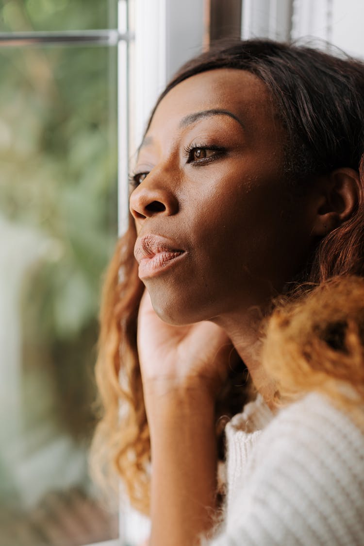 Woman Looking Through Window