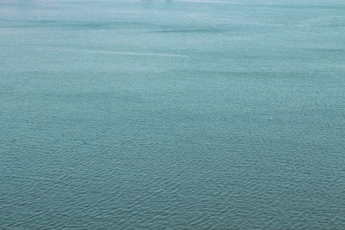 Free A serene aerial shot of the calm blue ocean surface with gentle waves. Stock Photo