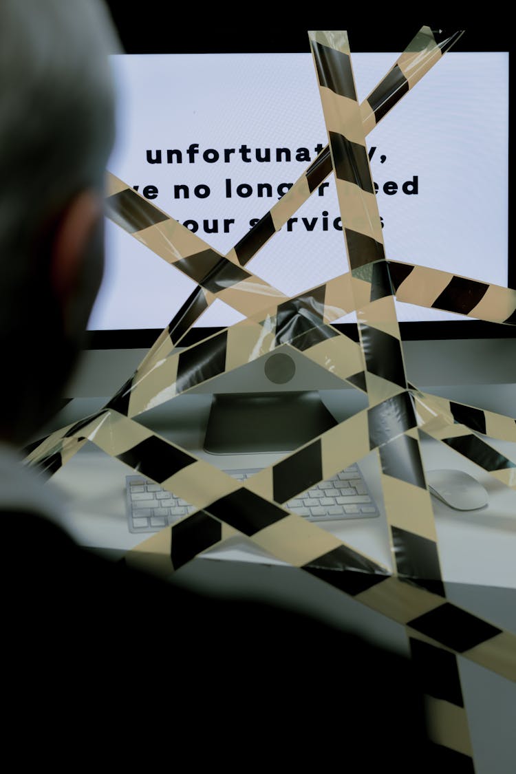 Man Sitting In Front Of Computer Facing Unemployment