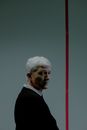 Man with gray hair behind red line