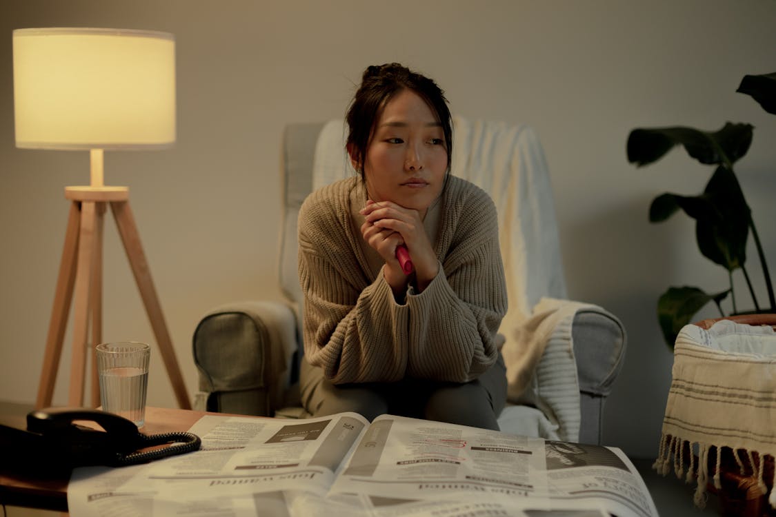 Portrait of unemployed woman sitting on armchair