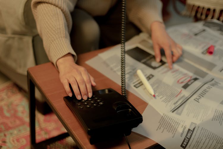 Woman Calling On Phone While Searching For Work