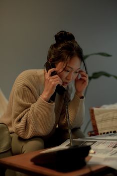 Focused woman analyzing job listings while on a call, showcasing career transition.