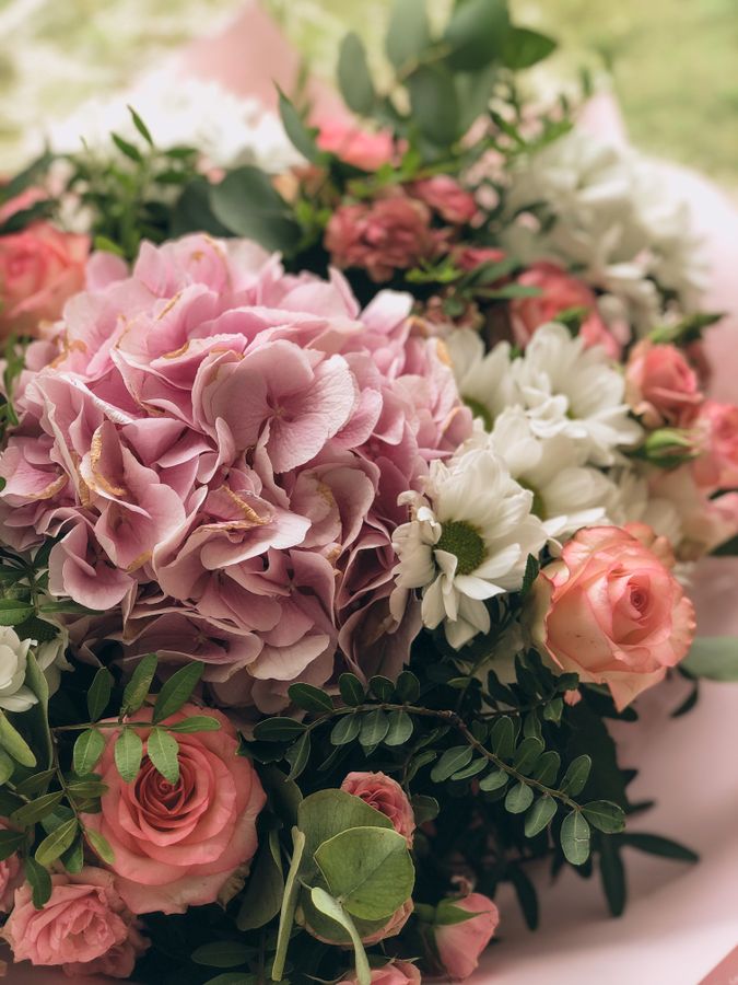 Lush pink flower arrangement in a wide ceramic vase