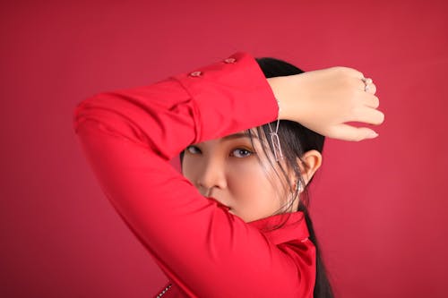 A Woman in Red Long Sleeves Wearing Silver Jewelries