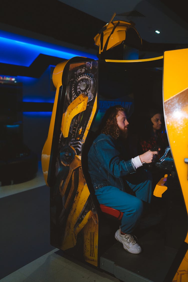 A Man In Denim Jacket Sitting Inside The Booth