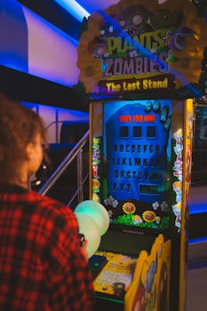 A person playing a Plants vs Zombies arcade game in an entertainment venue.